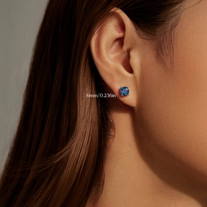 Royal blue rose cut 6mm S925 sterling silver stud earrings worn by a model