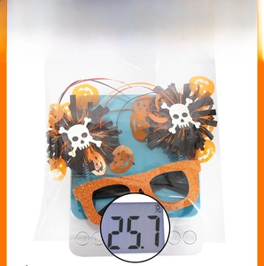 Weight measurement of Halloween pumpkin skull party glasses at 25.7g on scale