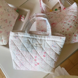 Quilted floral handbag with pastel patchwork patterns and a 'Simple Wish' fabric label