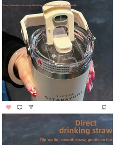 Close-up of cream-white insulated stainless steel tumbler with handle and clear lid