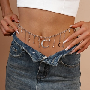 Detail of silver waist chain featuring rhinestone star and moon pendants with tassels