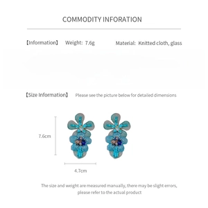 Detailed view of knitted flower earrings showing 7.6cm height and glass diamond inlay