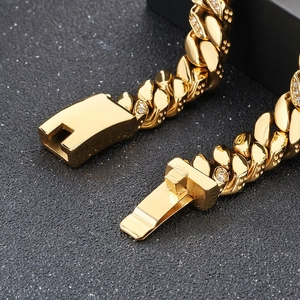 Macro shot of 12mm gold Cuban chain link bracelet with box clasp and sparkling crystals