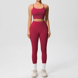 Close-up of high-waist yoga set in deep red with fine straps and matte elastic fabric