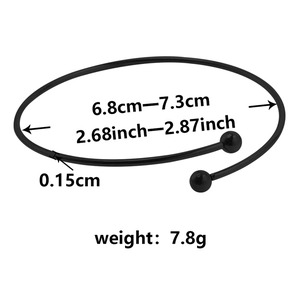 Detail view of adjustable black stainless steel bangle showing size and weight specs