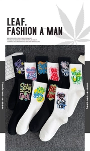 Detail of high-stretch athletic crew socks featuring colorful graffiti lettering on cotton