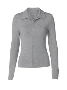 Detail of grey knitted cardigan showing fine texture and metallic snap buttons on the front