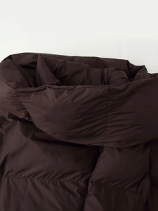 Detailed close-up of dark brown padded jacket neckline with detachable hooded scarf