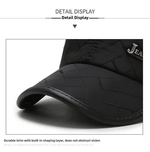 Detail of quilted baseball cap featuring leather brim piping and metal JEAN logo