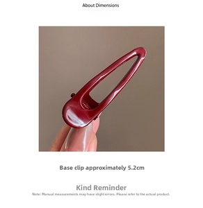 Detailed view of a burgundy red metal hair clip with a length of about 5.2cm