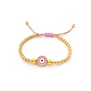 Detailed view of handmade beaded evil eye bracelet with adjustable pink cord and gold beads