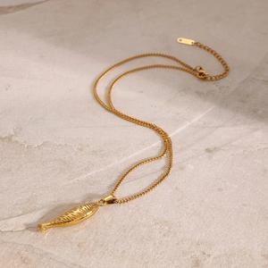 Detail of a gold stainless steel cross chain with a small fish pendant and adjustable clasp
