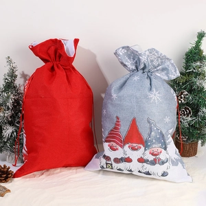 Christmas burlap gnome drawstring gift bags in red and grey with festive snowflake patterns