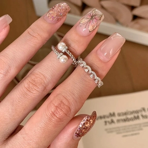 Elegant silver twisted pearl ring and zircon wave band set worn on a finger
