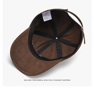 Interior view of brown cotton baseball cap showing six-panel stitching and metal buckle