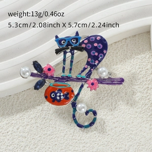 Detail of cartoon cat brooch with blue glasses and fish bowl charm on white background