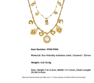 Detail of layered gold necklaces with enamel heart, owl, and zircon icon pendants