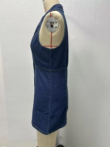 Side view detail of a deep blue denim sleeveless dress with button accents and A-line waist