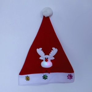 Close-up of glowing reindeer nose and glittery snowflakes on kids Christmas hat