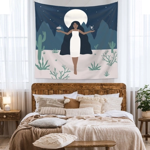 Bedroom wall decor featuring a bohemian tapestry with a woman in a moonlit desert scene