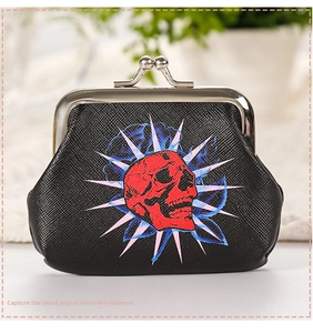 Close-up of retro coin purse featuring red skull print and classic metal kiss-lock closure