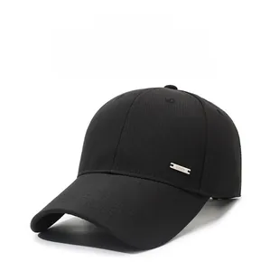 Detailed macro view of the breathable fabric and silver metal logo on a black baseball cap