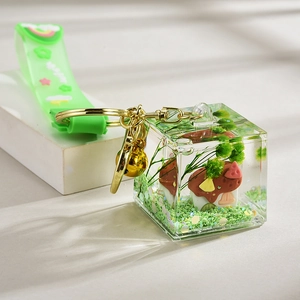 Miniature mushroom house acrylic keychain with green glitter and silicone strap
