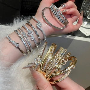 Detailed view of 18k gold plated bracelets with zircon hearts and buckle closures