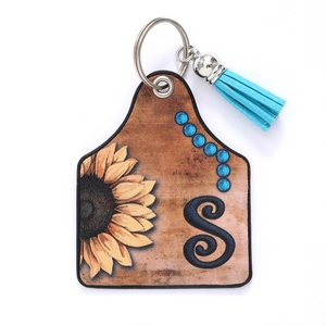 Western style leather ear tag keychain with sunflower, letter S and blue tassel