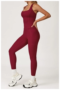 Detail view of burgundy yoga leggings with side pockets and racerback sports bra