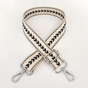 Adjustable beige nylon strap with black chevron pattern and silver metal hardware details