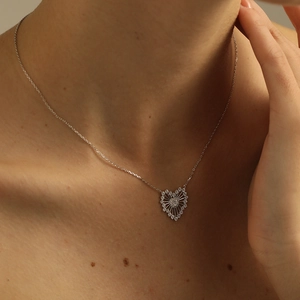 S925 sterling silver heart necklace with zircon inlay worn on a model neckline