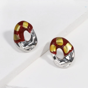 French vintage dark red enamel stud earrings with gold plating on textured background