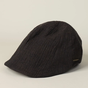 Close-up of vintage dark brown linen ivy cap with vertical pleats and metal detail