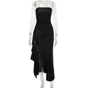 Detail of sparkly black strapless dress featuring ruffled side and high slit design