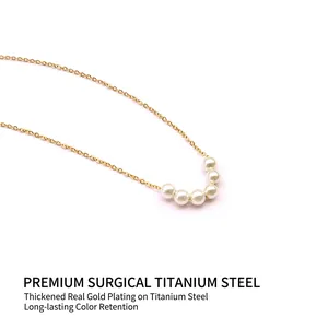 Detail of 18K gold-plated titanium choker featuring five round white pearls and fine chain