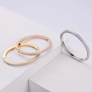 Detailed view of luxury 18K gold and silver plated bangles set with sparkling zircon stones