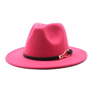 Detail of fuchsia wool fedora hat featuring black leather band and gold buckle accent