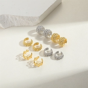 Detailed view of 14K gold and silver plated copper ear cuffs with textured patterns