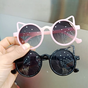 Detail view of pink and black cat-ear sunglasses for kids with durable plastic frames