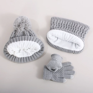 Three-piece winter set with grey knit beanie, scarf, and gloves featuring thick fleece lining