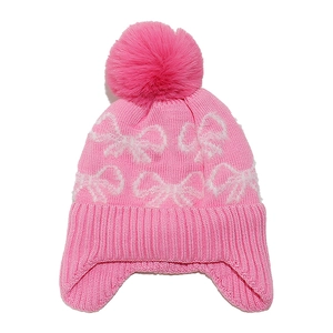 Pink knitted baby winter hat with white bow pattern and soft fluffy pom pom on top