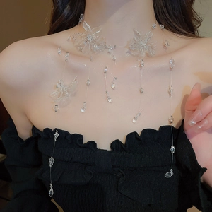 Detail of transparent floral tassel necklace with acrylic petals and beaded fringe