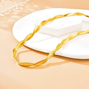 Golden double-strand twisted snake chain necklace in punk style on white display