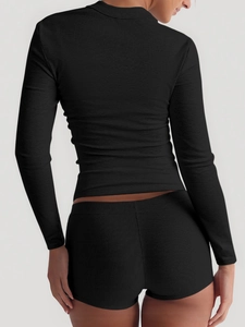 Rear view of black ribbed knit long sleeve crop top and matching high elastic shorts set