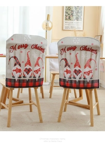 Detail of Christmas gnomes chair covers with red plaid trim and Merry Christmas text