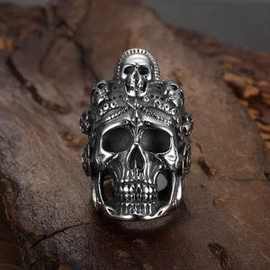 Gothic hollow skull ring in silver-black punk style displayed on a natural wood base