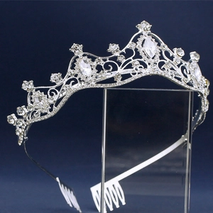 Detail of silver bridal crown headband featuring shiny rhinestones and comb design