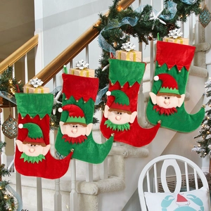 Set of 4 Christmas elf stockings hanging on white stairs with warm festive lighting
