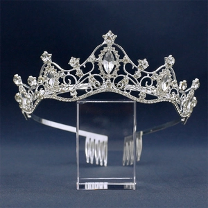 Macro detail of silver bridal tiara with sparkling marquise rhinestones on blue background